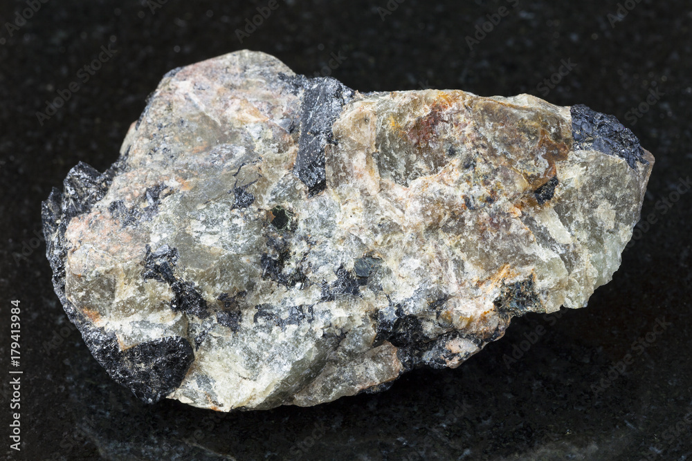 raw green Nepheline stone on dark e background