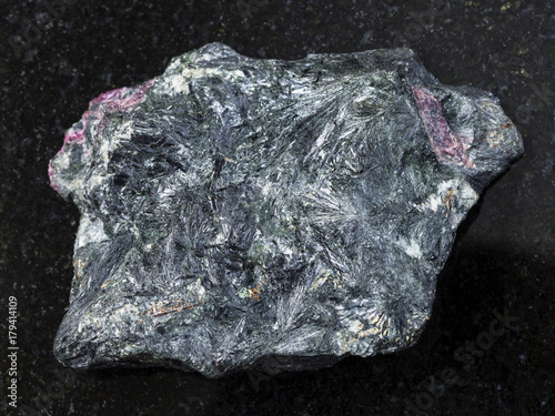 raw aegirine stone on dark background photo