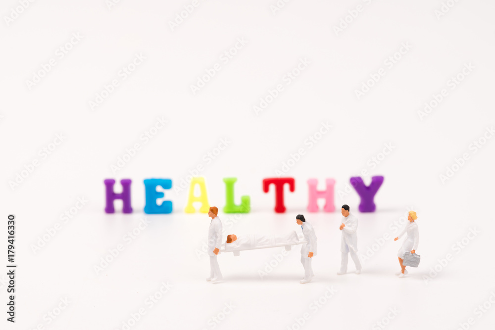 miniature peaple healthy teamwork help patient with HEALTHY text background miniature peaple healthy teamwork help patient with HEALTHY text background