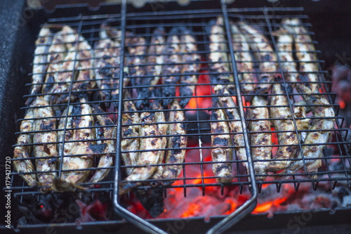 fried fish in grilled coals photo