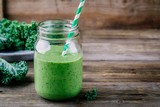Healthy detox green smoothie with kale in mason jar on wooden background