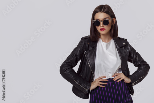 Young beautiful woman in a black jacket and sunglasses