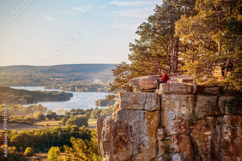 Man sitting on rock outcrop at Gibraltar Rock, Wisconsin. photo