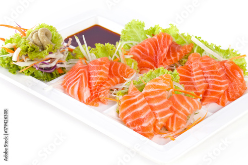 raw salmon with wasabi and sauce isolated on white plate on white background