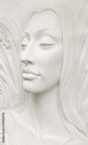 Bas-relief sculpture of a young woman face in profile