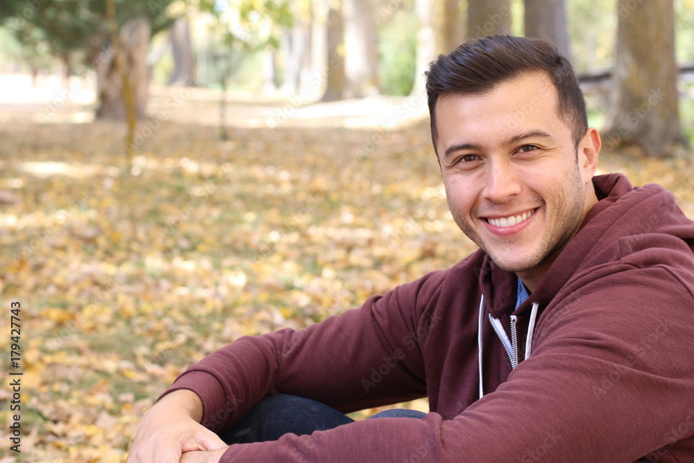 Mixed race male smiling in the fall with copy space Mixed race male smiling in the fall with copy space