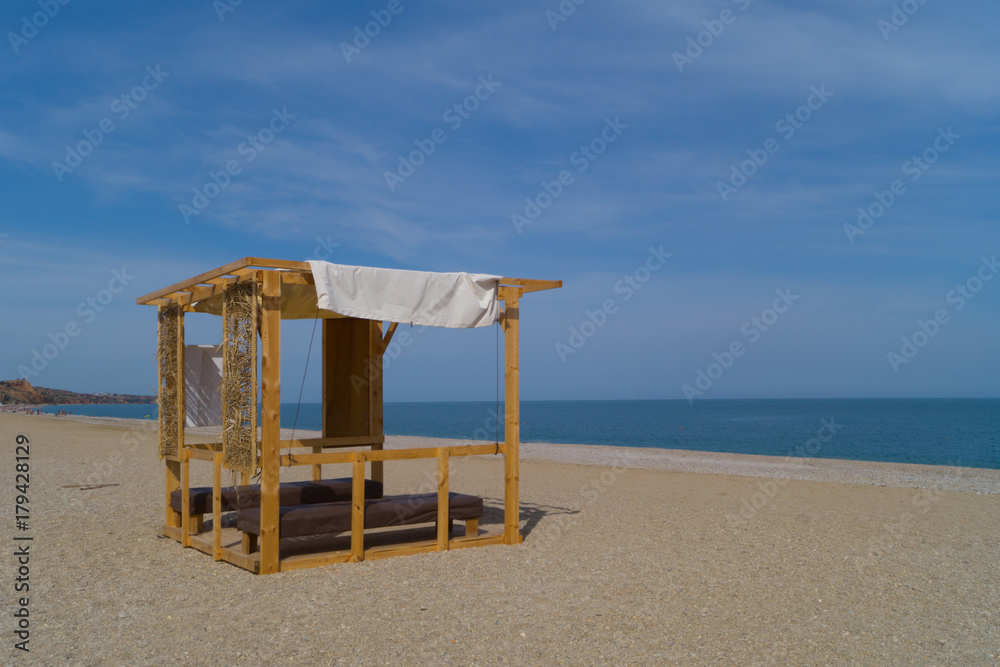 Wooden massage parlor with two tables on the beach Wooden massage parlor with two tables on the beach