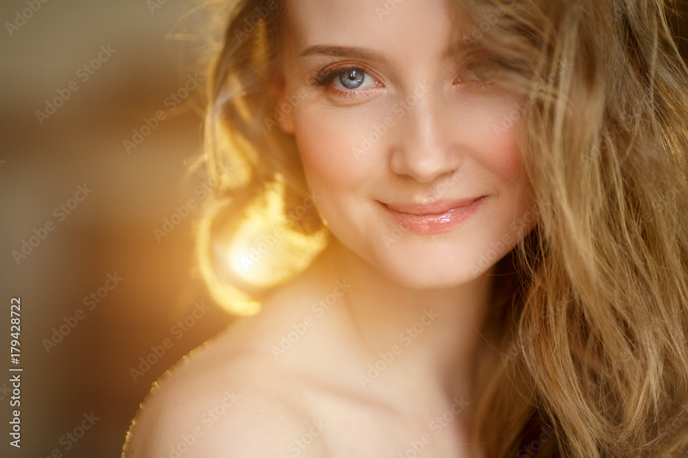 Romantic blonde. Young beautiful cute woman. Beauty girl with long shiny hair, glowing skin and voluminous haircut Romantic blonde. Young beautiful cute woman. Beauty girl with long shiny hair, glowing skin and voluminous haircut
