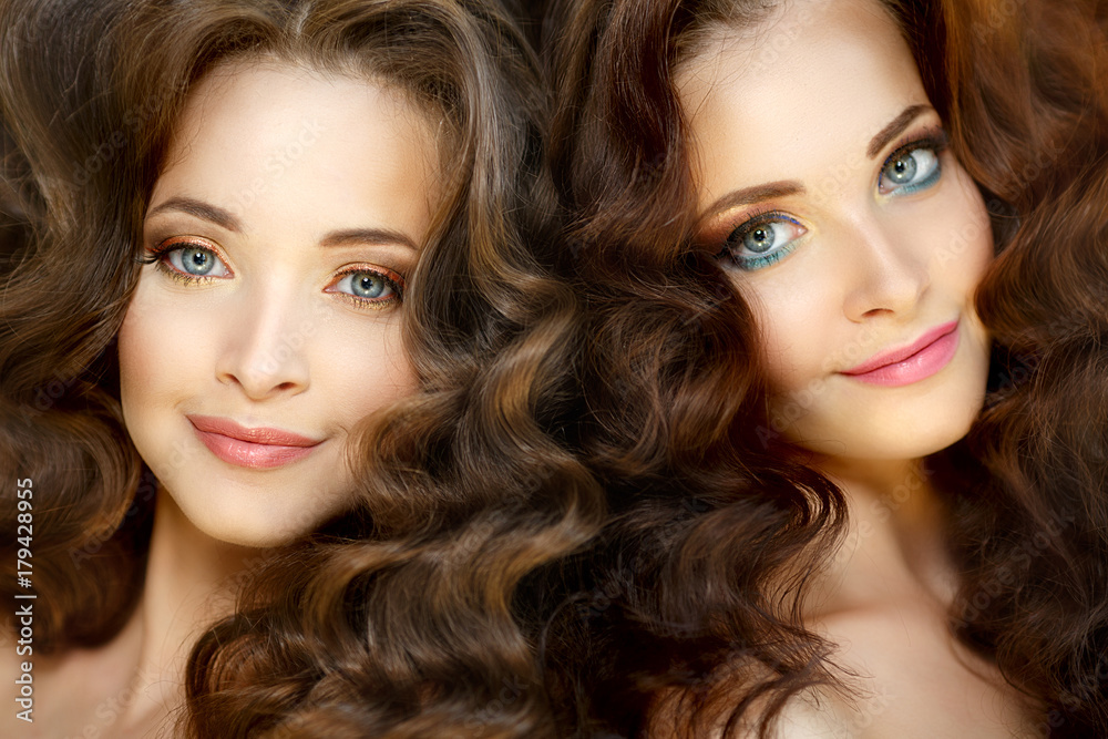 Naklejka premium Young beautiful twins women with healthy skin and luxurious curly updo hair