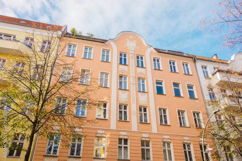 Obraz premium orange apartment building with white lines and stucco details