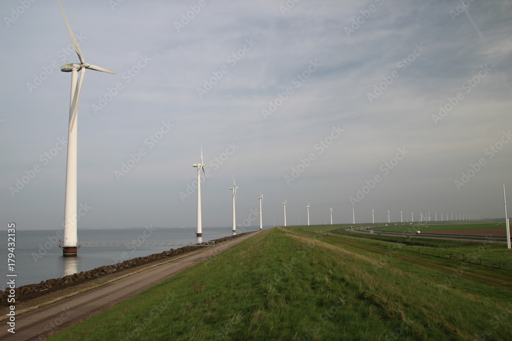 Windmills along the IJsselmeer in Flevoland, The Netherlands Windmills along the IJsselmeer in Flevoland, The Netherlands