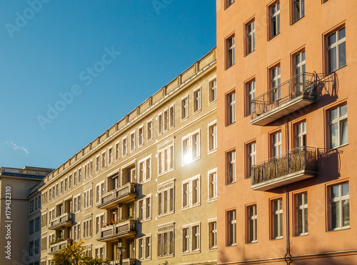 high contrasted picture of apartment building with lens flare in the windows