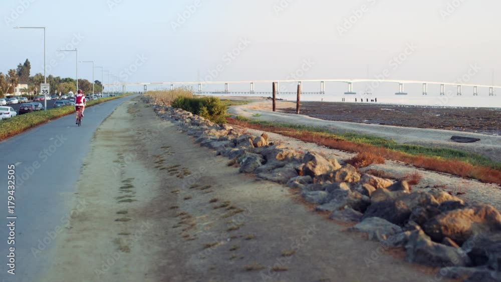 A bicyclist gets his exercise by going for an early morning ride in the San Francisco Bay area. A bicyclist gets his exercise by going for an early morning ride in the San Francisco Bay area.