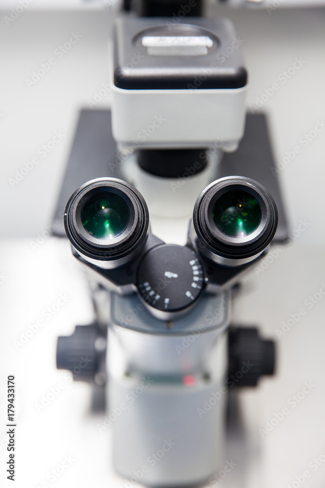 Close up of stereo microscope eyepieces in the laboratory