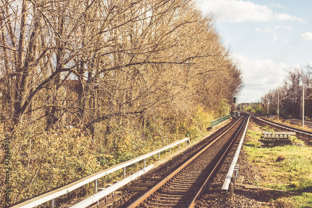 rails on trainstation with nature background