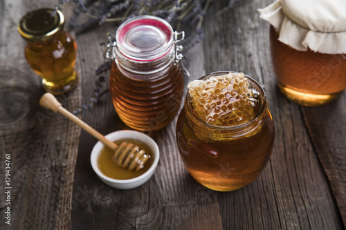 Jar full of fresh honey and honeycombs