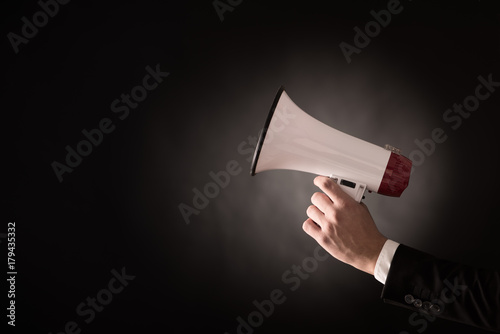 Murais de parede Hand of a businessman holding a megaphone