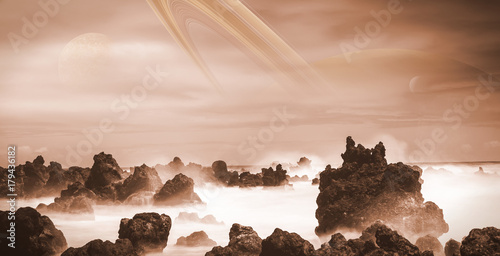 Fototapeta Naklejka Na Ścianę i Meble -  view at Saturn from the moon Titan, alien landscape with ocean and strange rock formations 
