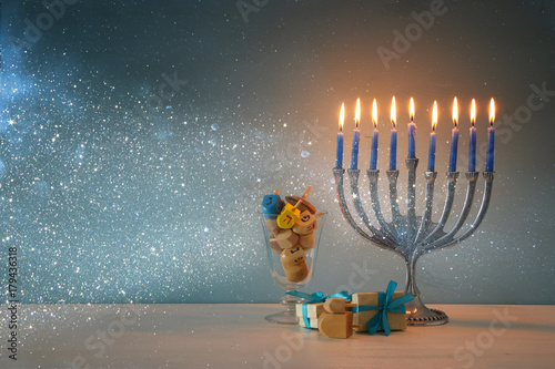 image of jewish holiday Hanukkah background with menorah (traditional candelabra) and burning candles.