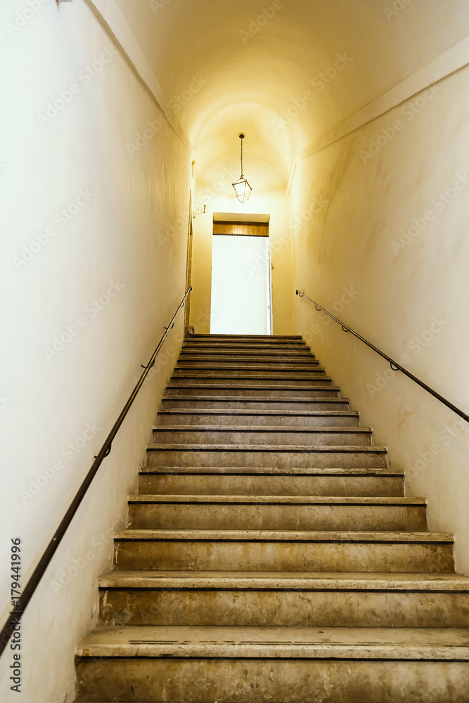 Old staircase with metal wall mounted handrail Old staircase with metal wall mounted handrail