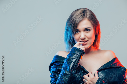Portrait of beautiful young happy woman nibbling on her finger