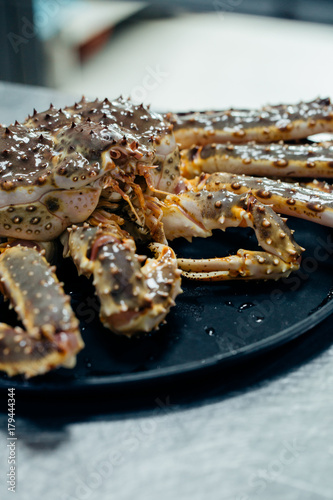 Taraba sea crabs or alaska king crab on black plate photo