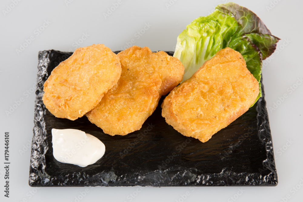 fish fried on a black slate with salad fish fried on a black slate with salad