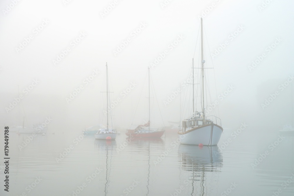 Sailing boats in the fog.