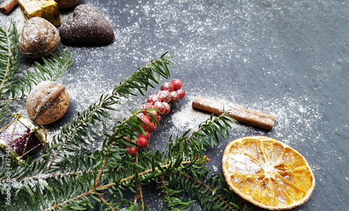 Christmas background with snow fir tree, nuts and gingerbreads