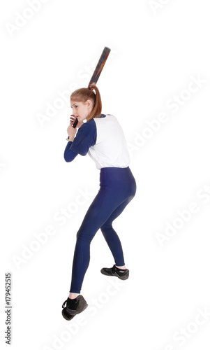 Woman swinging her bat in softball