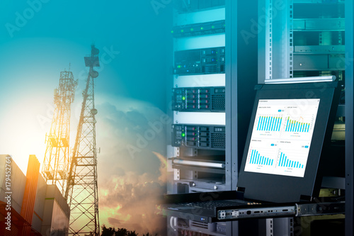Tableau sur toile Management monitor with charts on screen in data center and telecommunication tower on blue sky with cloud, double exposure