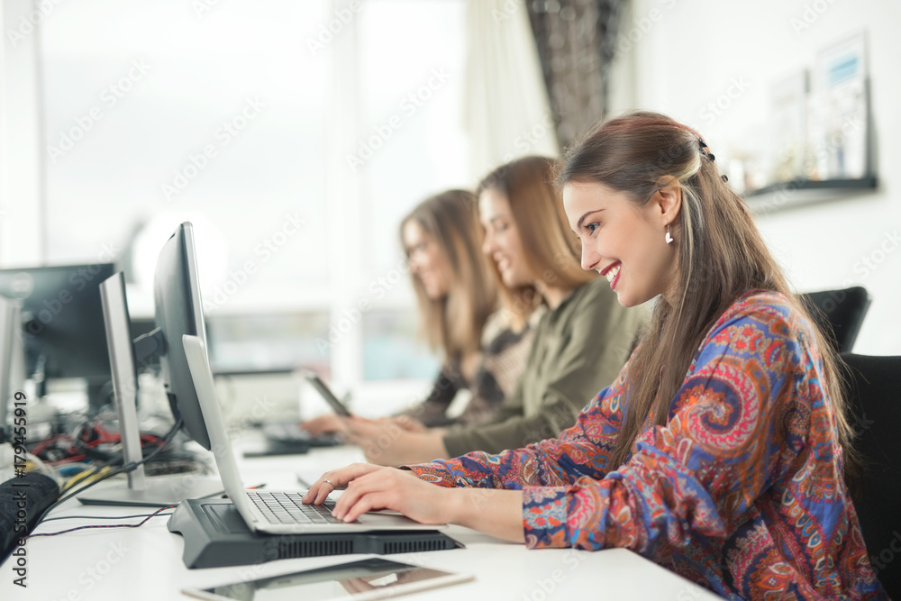 Group of young businesswomen working on their computers in the office