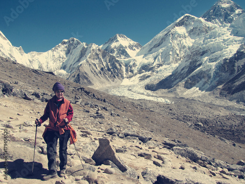 a young tourist woman against the backdrop of the highest mountain of Everest