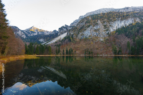 Fototapeta Naklejka Na Ścianę i Meble -  Reflection on Lake Frillensee, Inzell, Bavaria, Germany at sunset in fall with Mount Hochstaufen in Background
