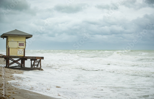 Beach view with waves. Morning on the ocean or sea beach. Lifeguard house. © goodmoments
