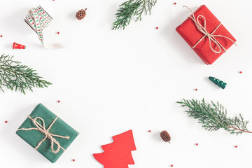 Christmas composition. Frame made of christmas gifts, pine branches, toys on white background. Flat lay, top view, copy space