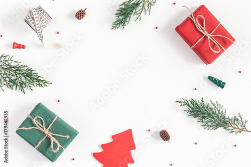 Christmas composition. Frame made of christmas gifts, pine branches, toys on white background. Flat lay, top view, copy space