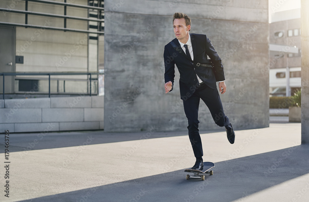 Confident successful man in suit riding skateboard Confident successful man in suit riding skateboard
