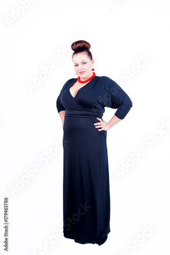 Obraz na plátně Beautiful confident buxom woman in black evening dress in full, with red costume