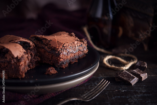 Brownie chocolate cake on dark moody background