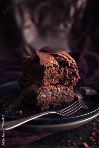 Brownie chocolate cake on dark moody background