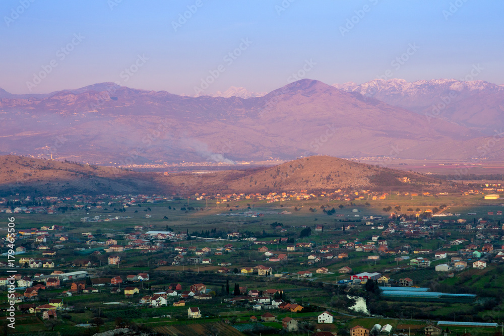 panorama of unreal sunrise, mountains and village