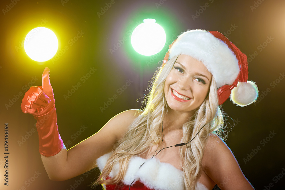 DJ girl in Santa Claus costume for Christmas. Stock Photo | Adobe Stock