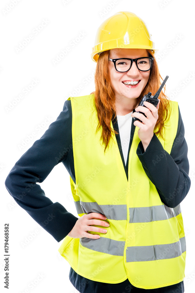smiling girl foreman with radio in hand on white background