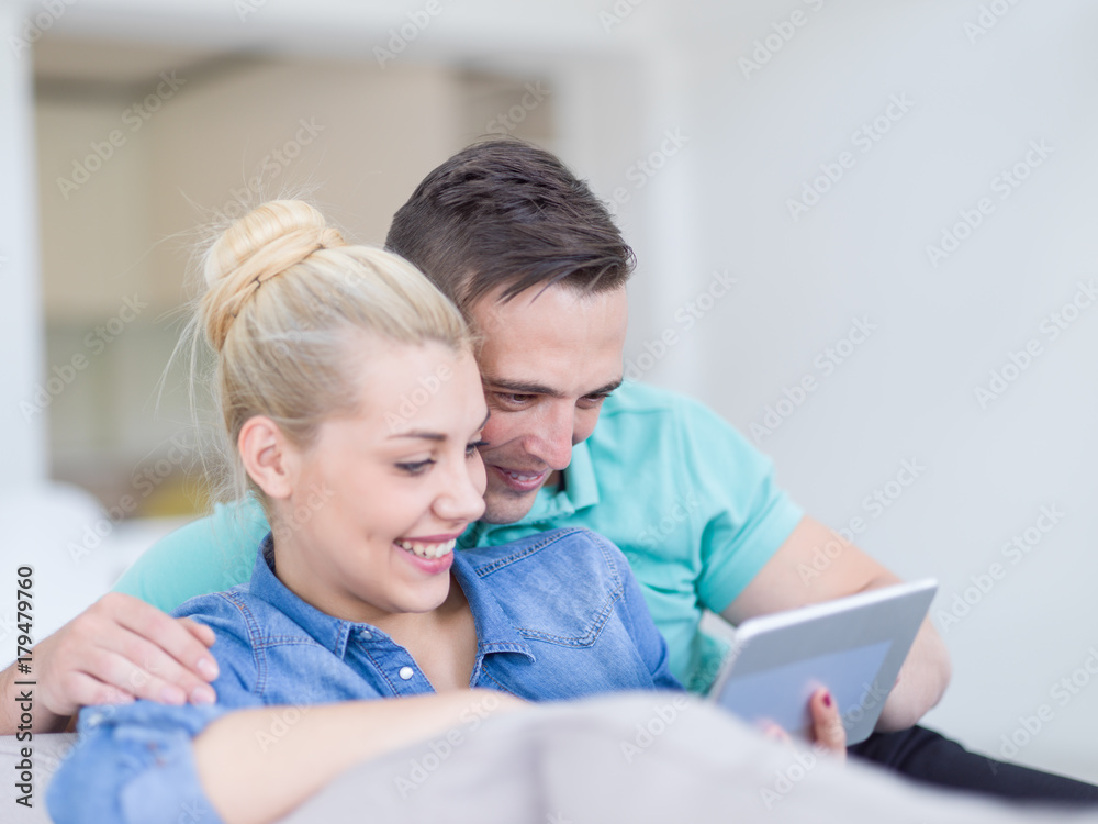 couple relaxing at home with tablet computers couple relaxing at home with tablet computers