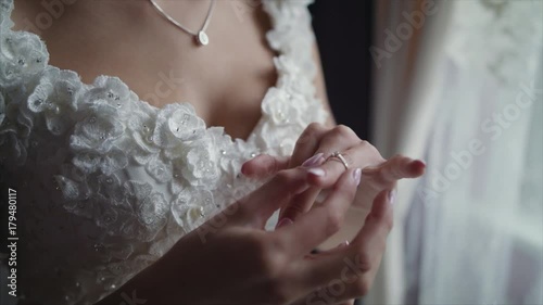On a wedding day groom puts a wedding ring on finger of a bride. Bride puts a ring on finger of a groom blackmagic ursa mini 4,6k photo