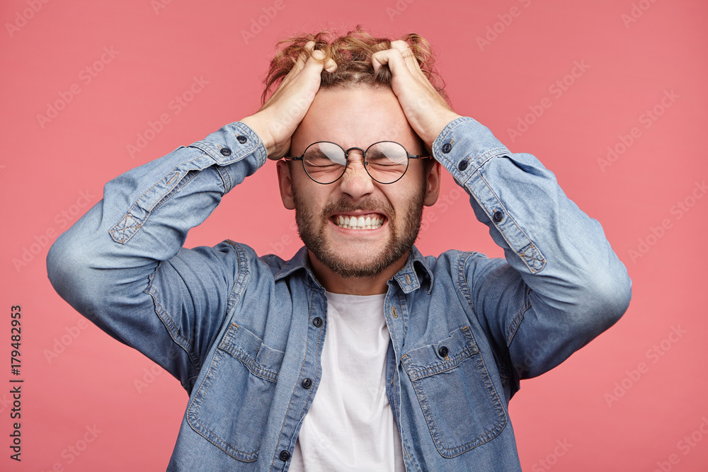 Mad crazy man regrets awful mistake, clenches teeth with annoyance, understands that he can`t change anything or return time back to improve situation, being in big panic and stress. Great desperation Mad crazy man regrets awful mistake, clenches teeth with annoyance, understands that he can`t change anything or return time back to improve situation, being in big panic and stress. Great desperation