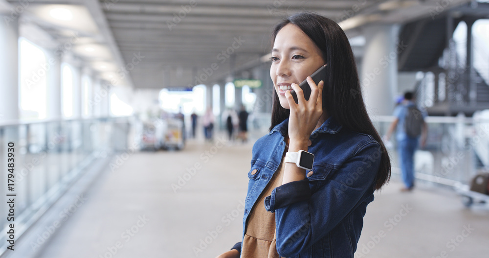 Woman talk to cellphone in airport