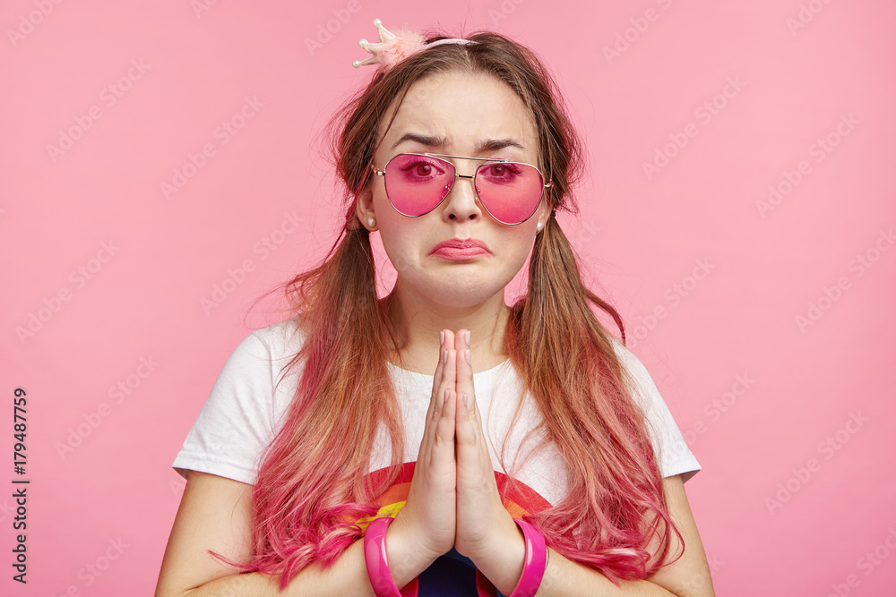 Pretty glamour coquette female with sorrorful regretful expression begs for forgiveness in her boyfriend, feels guilty, going to cry, isolated over pink background. Pinup girl prays for better in life Pretty glamour coquette female with sorrorful regretful expression begs for forgiveness in her boyfriend, feels guilty, going to cry, isolated over pink background. Pinup girl prays for better in life