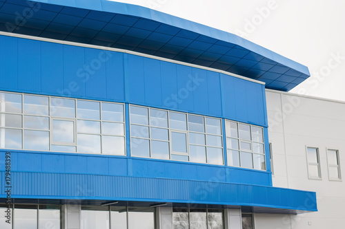 Part of a modern office building blue and white in color.